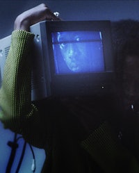 a person holding a tv over their head