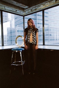 a woman standing in front of a large window