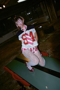 a girl sitting on a table