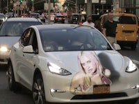 a white tesla model s with a picture of a woman on it