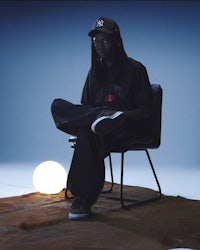 a man sitting on a chair in front of a light